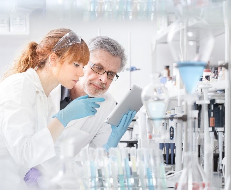 A picture of a male and female researcher in a lab using an iPad