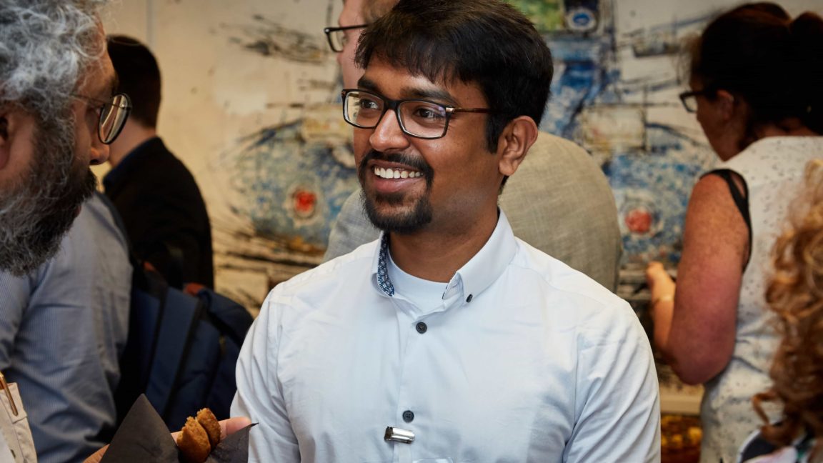 A picture of a smiling researcher at a Translate event